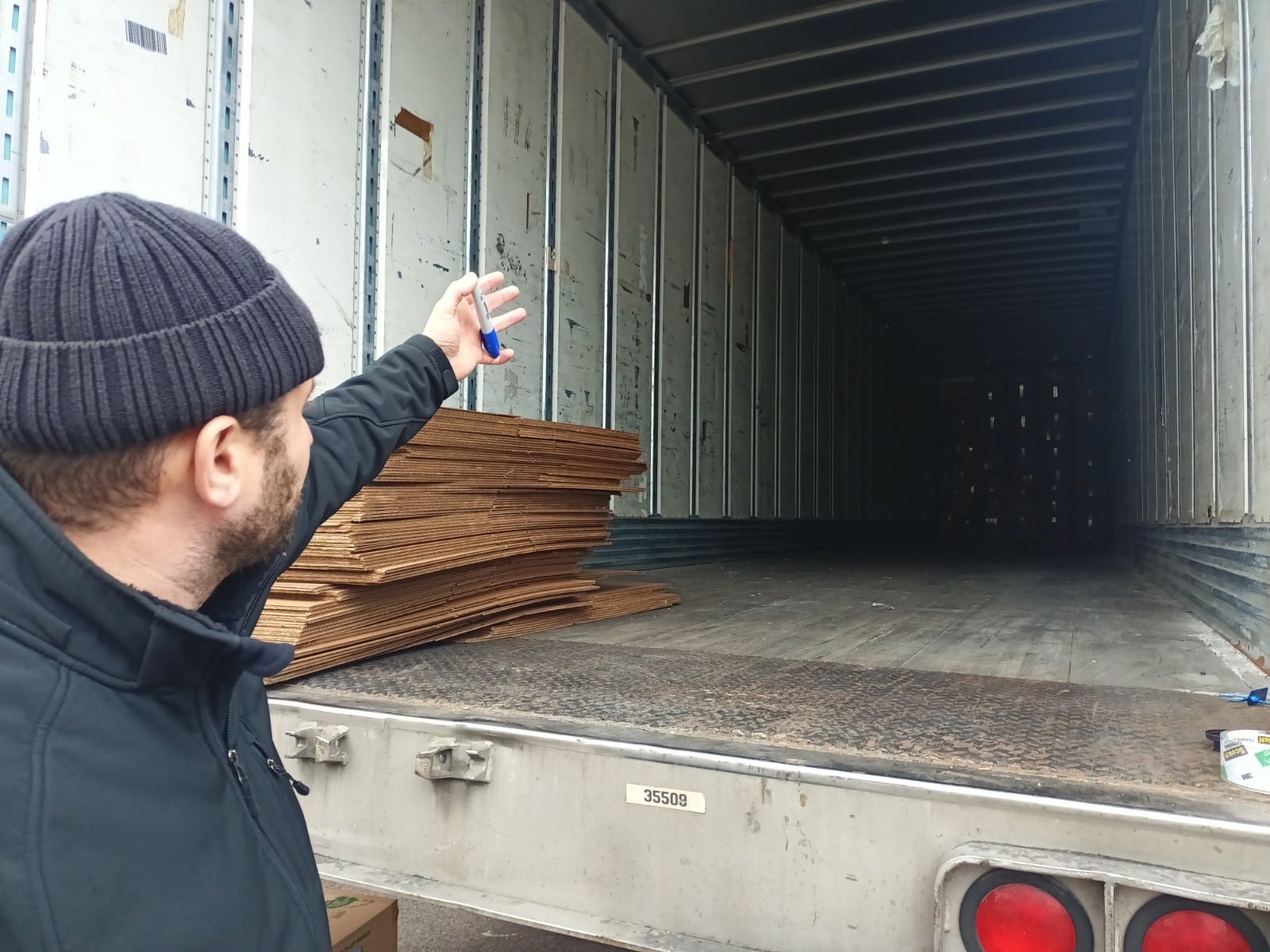 Bayram Gulaliev, a board member of the Osman Gazi Mosque, points to a freight trailer that they are hoping to fill with donations from the local community to send to Turkey. Approximately 30 boxes were filled by Tuesday afternoon, and donations will be accepted at the Mosque, located at 1508 Valley St. in Dayton, between 10 a.m. and 5 p.m. through Friday. SAMANTHA WILDOW\STAFF