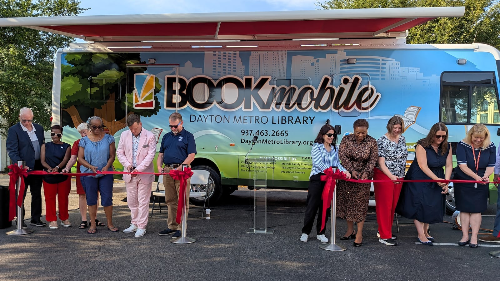 Staff and donors cut the ribbon on the new Dayton Metro Library Bookmobile, July 29, 2025. CONTRIBUTED