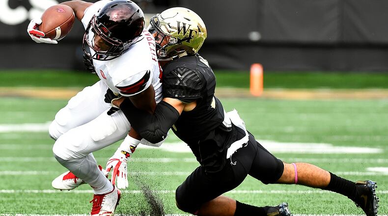WINSTON SALEM, NC - OCTOBER 28: Defensive back Jessie Bates III #3 of the Wake Forest Demon Deacons tackles wide receiver Dez Fitzpatrick #87 of the Louisville Cardinals during the football game at BB&T Field on October 28, 2017 in Winston Salem, North Carolina. (Photo by Mike Comer/Getty Images)