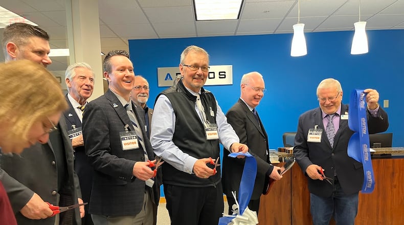 A ribbon was cut Tuesday on new Mission Point offices for Beavercreek defense contractor ARCTOS Technology Solutions. From the right are Beavercreek Mayor Bob Stone and Chris Greamo, the company's president and chief executive. THOMAS GNAU/STAFF
