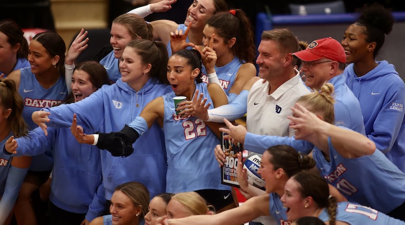Dayton celebrates coach Tim Horsmon's 400th career victory with the program after a match against Davidson on Friday, Nov. 8, 2024, at the Frericks Center in Dayton. David Jablonski/Staff