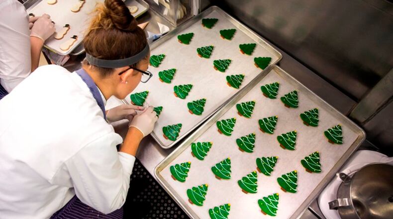A pastry chef works on cookies at the White House kitchen in Washington, Dec 3, 2015. Chefs and other employees at the White House have a busy schedule during the holiday party season, baking 25,000 cookies and preparing dishes of all sorts.