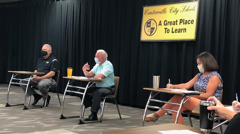 From left, Centerville school board President John Doll, Superintendent Tom Henderson and school board member Allison Durnbaugh discuss COVID protocols at a public meeting. JEREMY P. KELLEY / STAFF