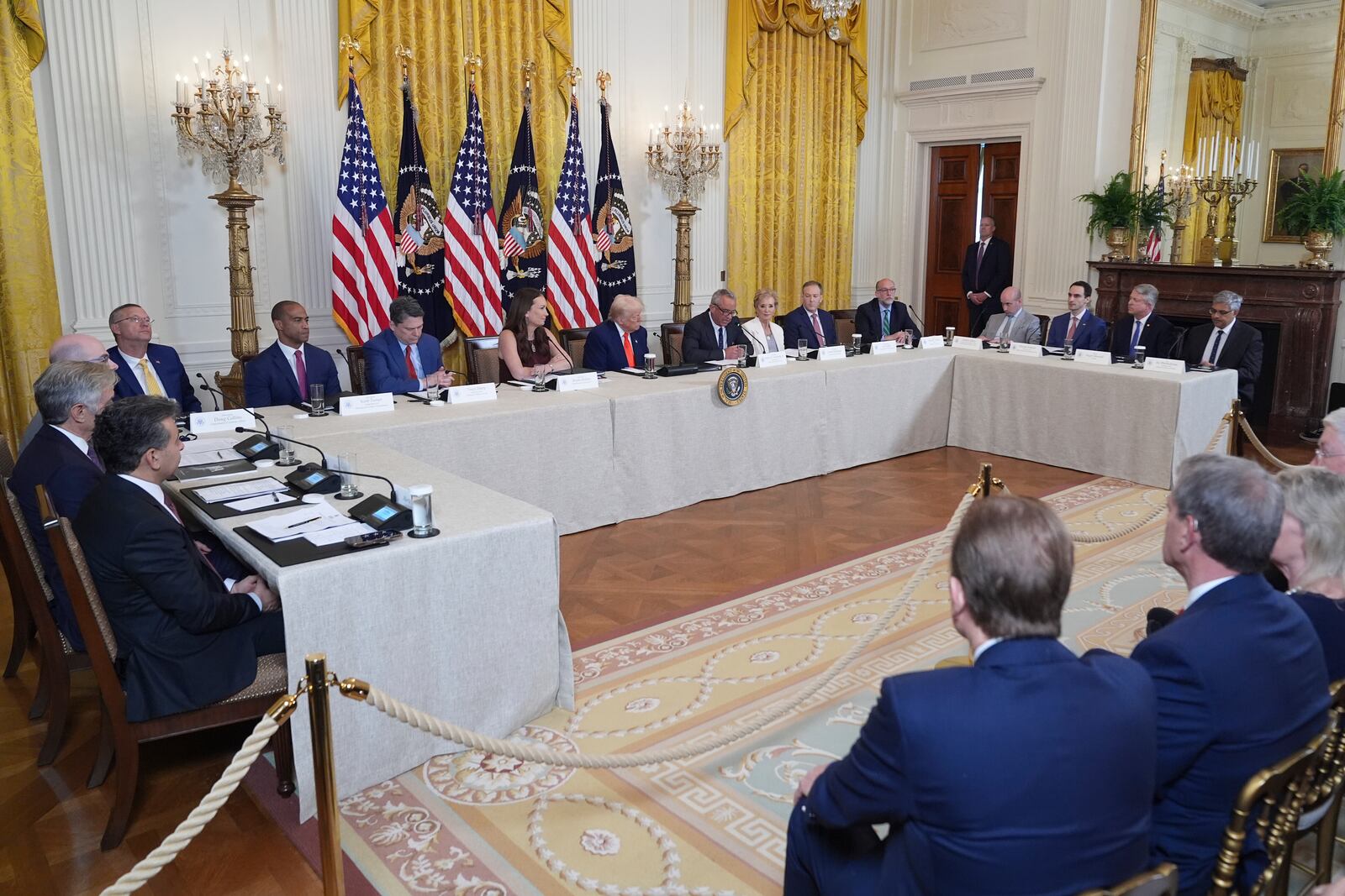 President Donald Trump, seated and center, listens during a Make America Healthy Again (MAHA) Commission Event in the East Room of the White House, Thursday, May 22, 2025, in Washington. (AP Photo/Jacquelyn Martin)