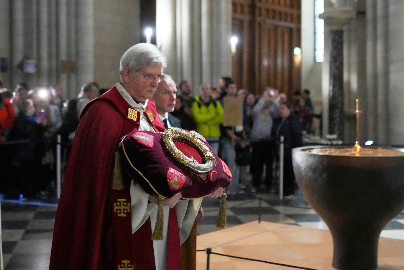 Paris Archbishop Laurent Ulrich holds the ancient relic that many Christians revere as Jesus Christ's "Crown of Thorns" during a ceremony to mark Good Friday at Notre Dame cathedral, Friday, April 18, 2025 in Paris. (AP Photo/Michel Euler)