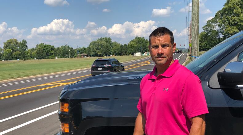 Ed Standifer stands in his driveway in Springboro. An entrance to a new subdivision is to be built next door.