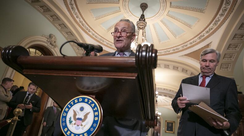 Senate Minority Leader Chuck Schumer, D-N.Y., joined at right by Sen. Sheldon Whitehouse, D-R.I., says Senate Democrats will initiate a federal lawsuit if their requests for documents from Brett Kavanaugh’s days as a White House aide are denied, during a news conference on Capitol Hill in Washington, Thursday, Aug. 16, 2018. (AP Photo/J. Scott Applewhite)