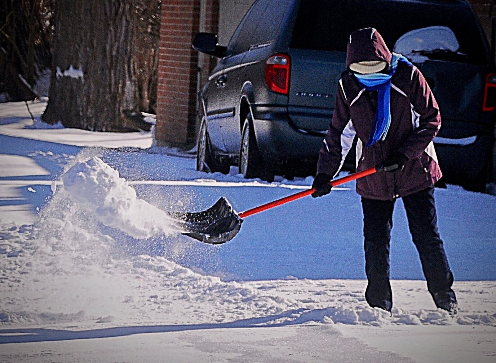 Bundled up and shoveling snow on Dayton Road near Enon on Sunday. Photo Marshall Gorby