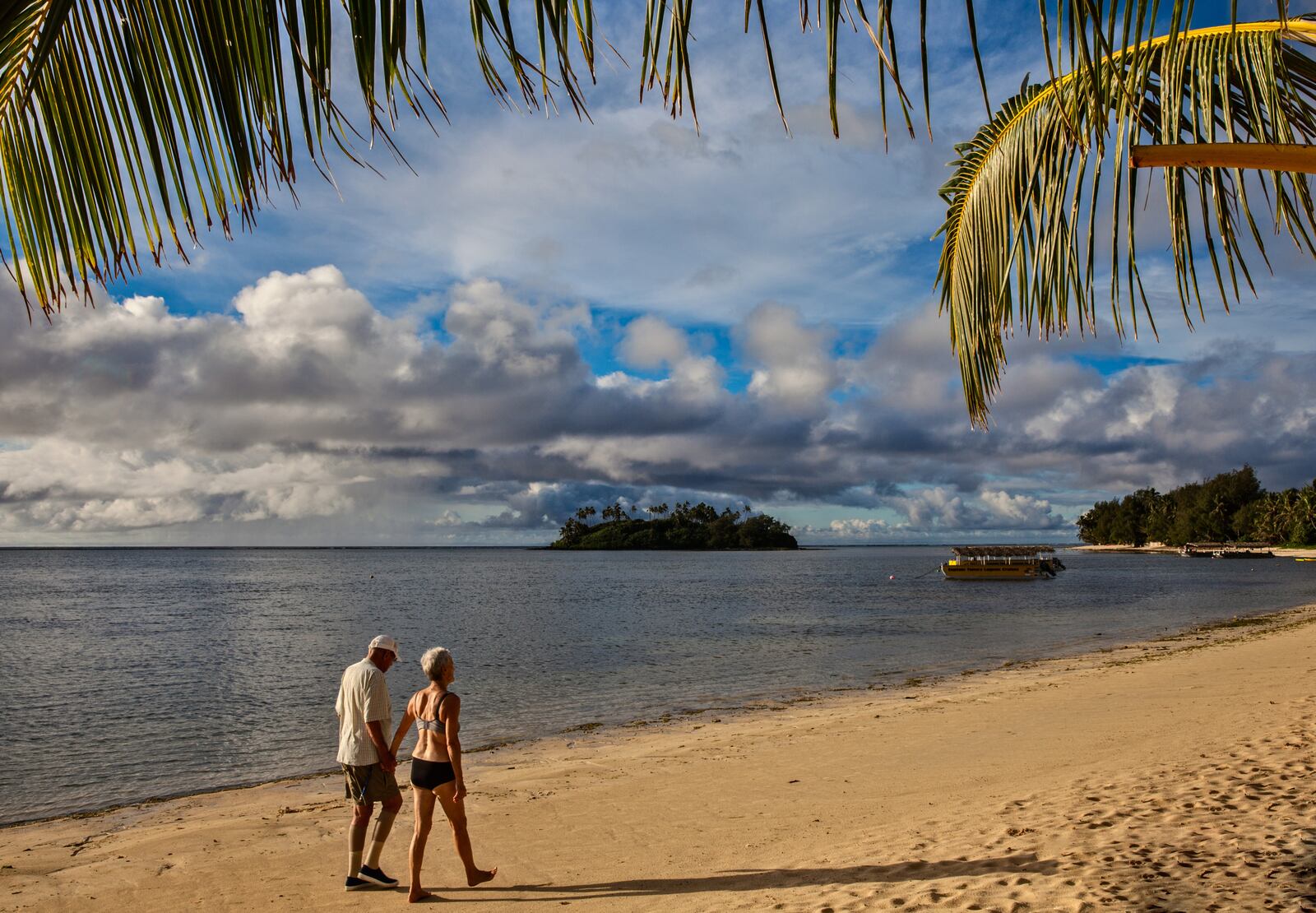 Strolling before breakfast on popular Muri Beach, with motu (islet) Taakoka and the outer reef at rear; Rarotonga, Cook Islands. (Steve Haggerty/ColorWorld/TNS)