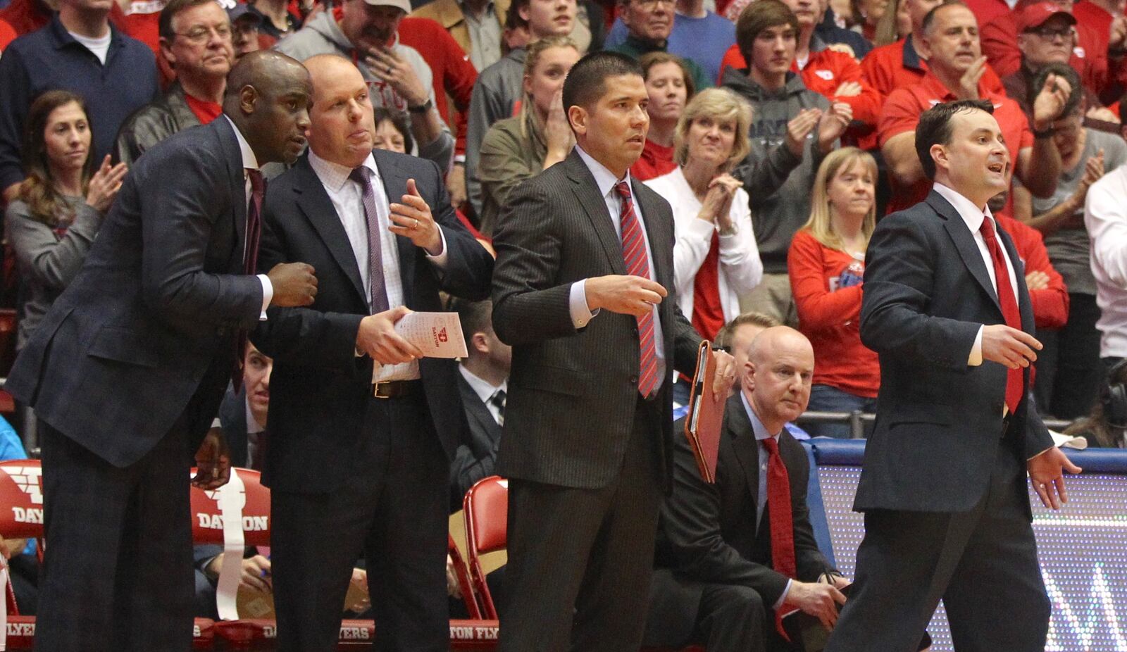 Dayton head coach Archie Miller, far left, and his assistants (left to right) Allen Griffin, Kevin Kuwik, Tom Ostrom and Bill Comar watch the action during the final minutes of a game against Virginia Commonwealth on March 1, 2017, at UD Arena.