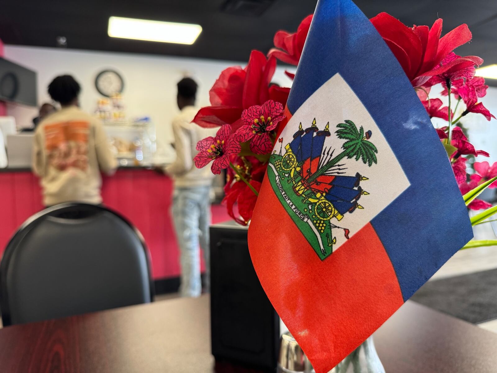 Haitian flags are displayed on all the tables at Rose Goute Creole Restaurant in Springfield Friday, Feb. 21, 2025. BILL LACKEY/STAFF