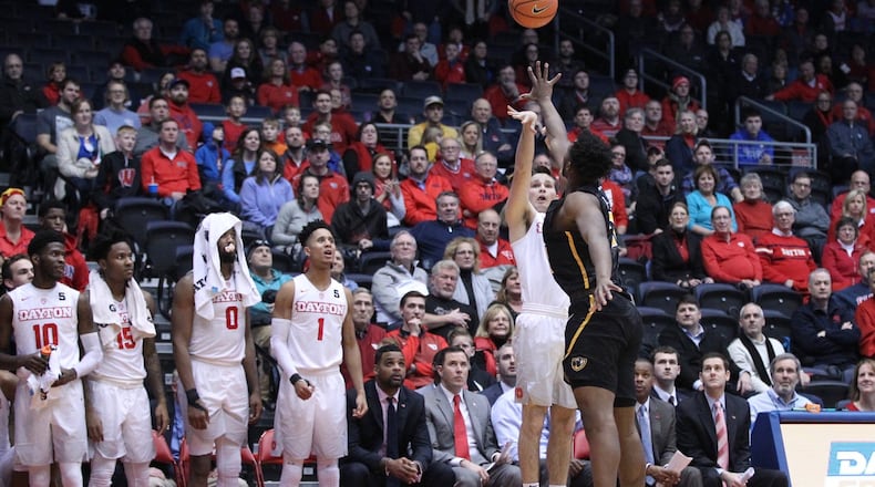 Dayton’s Joey Gruden makes a 3-pointer in the final minute against Virginia Commonwealth on Friday, Jan. 12, 2018, at UD Arena. David Jablonski/Staff
