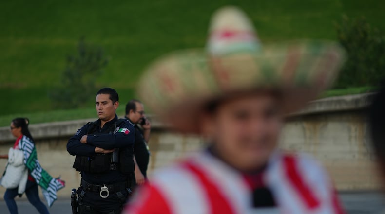 A police officer stands guard outside Akron Stadium prior to a friendly match between Mexico and Ecuador in Guadalajara, Mexico, Tuesday, Oct. 14, 2025. (AP Photo/Eduardo Verdugo)