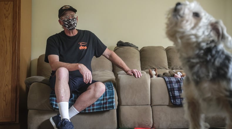 Michael Russell and his dog Rascal relax in their Dayton apartment Tuesday August 11, 2020. Michael Russell, an Air Force veteran received food vouchers and rental assistance through the Montgomery County Veterans Service Commission to help him through the pandemic. JIM NOELKER/STAFF