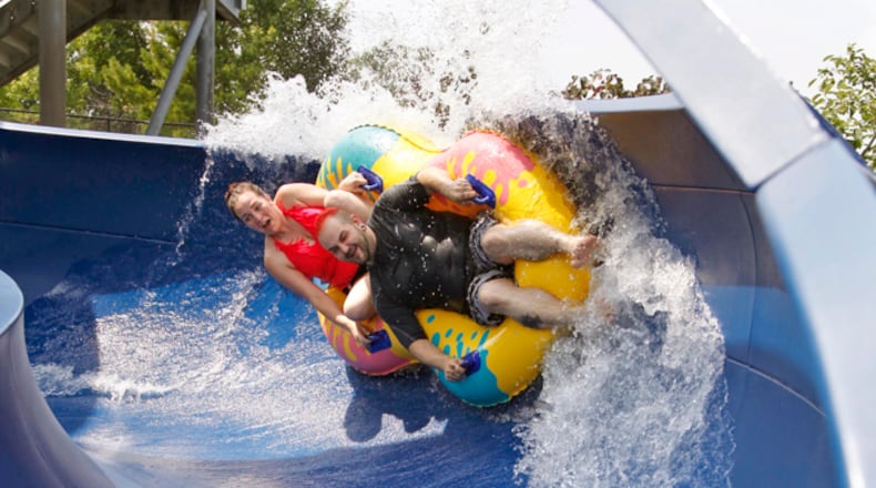Lexie Derasmo, left, and Steven Spady kept cool on Friday, July 19 at the Sycamore Trails Aquatic Center in Miamisburg. The two took many trips down the water slide. TY GREENLEES / STAFF