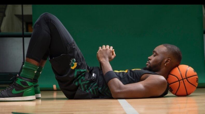 Jack Doumbia lays back in prayer before a practice. “There’s so much more than stats and how many points he averaged,” said Wright State coach Clint Sargent. “If you dig deeper into his past and what he has done, there’s an awful lot there.” CONTRIBUTED