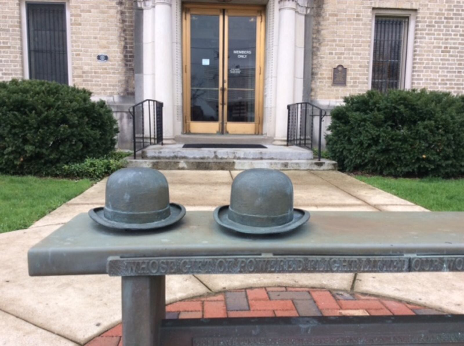 We think you probably know who is associated with the hats in this sculpture outside the Engineers Club of Dayton. Hint: they’re brothers. MARK FISHER/STAFF