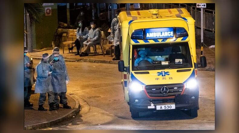 Police officers and medical workers outside an apartment building in Hong Kong on Tuesday, Feb. 11, 2020, where two residents were confirmed to have contracted the coronavirus. Officials have put into quarantine dozens of residents of the apartment building after the two people, who live on different floors, were found to be infected, authorities said on Tuesday. (Lam Yik Fei/The New York Times)