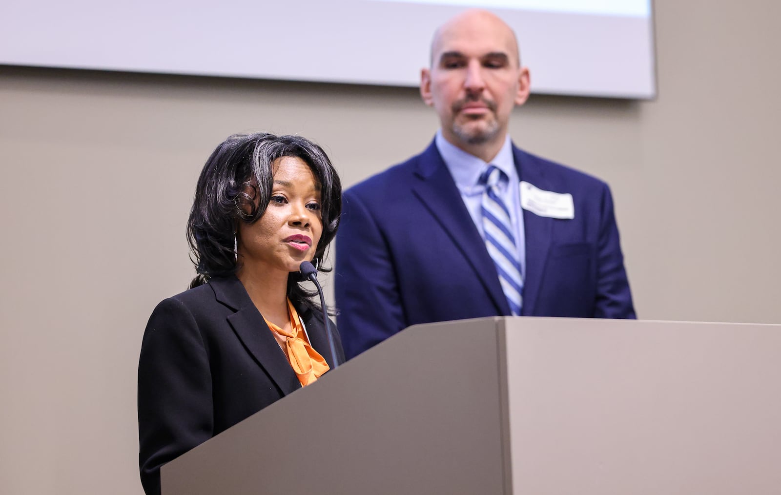 Dayton Mayor Shenise Turner-Sloss (left) speaks at an event at CareSource on Thursday, Dec. 8 in downtown Dayton as City Commissioner Matt Joseph listens. Turner’s director of community outreach, Regina Holman, said Thursday that downtown Dayton has seen great gains in development. BRYANT BILLING/STAFF