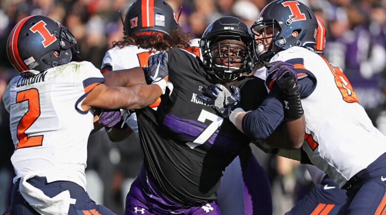EVANSTON, IL - NOVEMBER 26: Ifeadi Odenigbo #7 of the Northwestern Wildcats rushes against Reggie Corbin #2 (L) and Andrew Davis #89 of the Illinois Fighting Illini at Ryan Field on November 26, 2016 in Evanston, Illinois. (Photo by Jonathan Daniel/Getty Images)