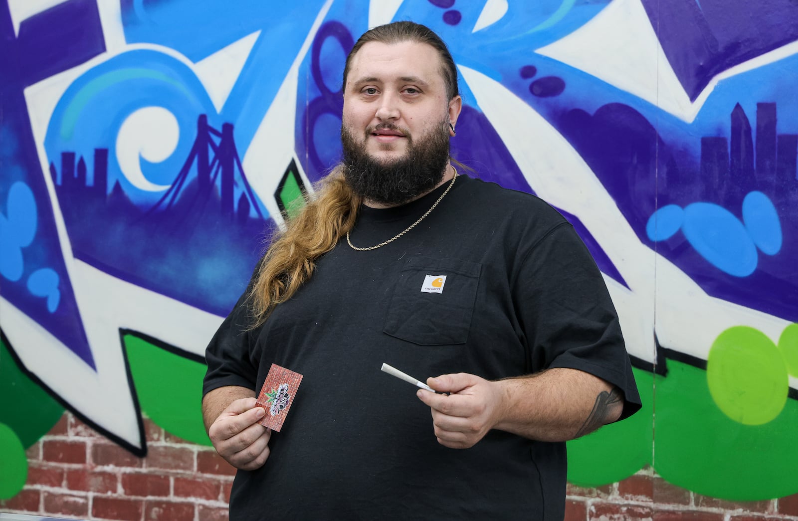 Jesse Burns, the co-owner of Bud City, poses for a photo at the store's Fairborn location, which opened in July. Marijuana is illegal to sell in Fairborn, but Bud City is selling products with hemp, which contains .3 percent or less of THC. BRYANT BILLING / STAFF