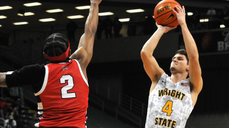 Wright State's Keaton Norris, 4, puts up a shot against Detroit Mercy's Kyle LeGreair, 2, during the first half of a Horizon League game at the Nutter Center on Friday, Jan. 6. DAVID A. MOODIE/CONTRIBUTING PHOTOGRAPHER