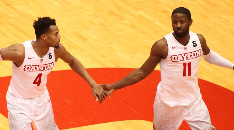 Dayton’s Charles Cooke and Scoochie Smith slap hands after a basket against East Tennessee State on Saturday, Dec. 10, 2016, at UD Arena. David Jablonski/Staff