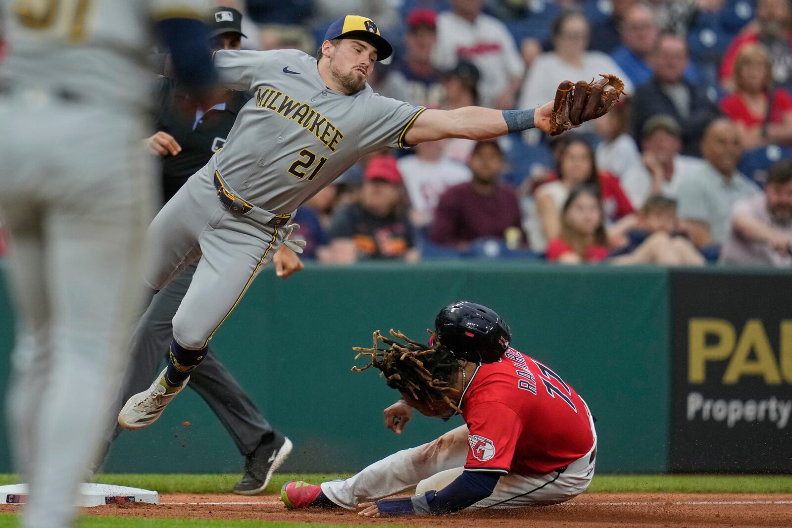 Cleveland Guardians' Jose Ramirez, right, steals second base as Milwaukee Brewers third baseman Caleb Durbin (21) takes the throw in the sixth inning of a baseball game in Cleveland, Monday, May 12, 2025. (AP Photo/Sue Ogrocki)