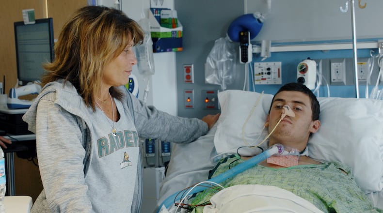 Former Wright State basketball player Ryan Custer and his mom, Kim. CONTRIBUTED