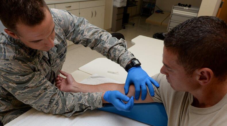 Capt. Nathen Holdman, 88th Medical Operations Squadron staff occupational therapist, performs therapeutic dry needling on the arm of Senior Master Sgt. Jon Garcia, Physical Medicine flight chief, inside the Physical Medicine Flight at Wright-Patterson Medical Center July 17. Dry needling relieves muscle tension and is an effective treatment for chronic pain. (U.S. Air Force photo/Michelle Gigante)