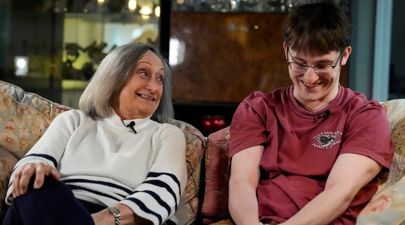 Donna West sits with her grandson Paul Quirk as they speak to a reporter, Tuesday, Dec. 2, 2025, in Marietta, Ga. (AP Photo/Mike Stewart)