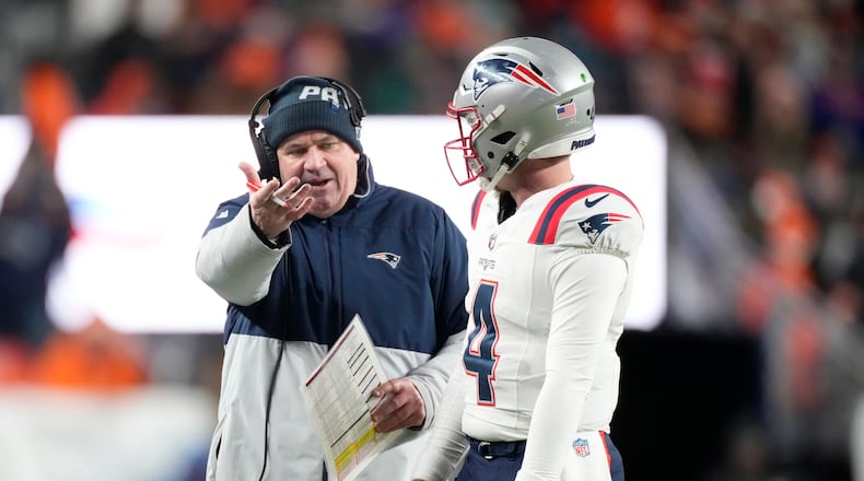 New England Patriots offensive coordinator Bill O'Brien talks to quarterback Bailey Zappe during the first half of an NFL football game against the Denver Broncos, Sunday, Dec. 24, 2023, in Denver. (AP Photo/David Zalubowski)