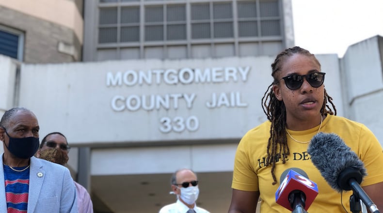 Daj’za Demmings, executive director of the Dayton Young Black Professionals, speaks at a press conference outside the Montgomery County Jail this morning. CORNELIUS FROLIK / STAFF