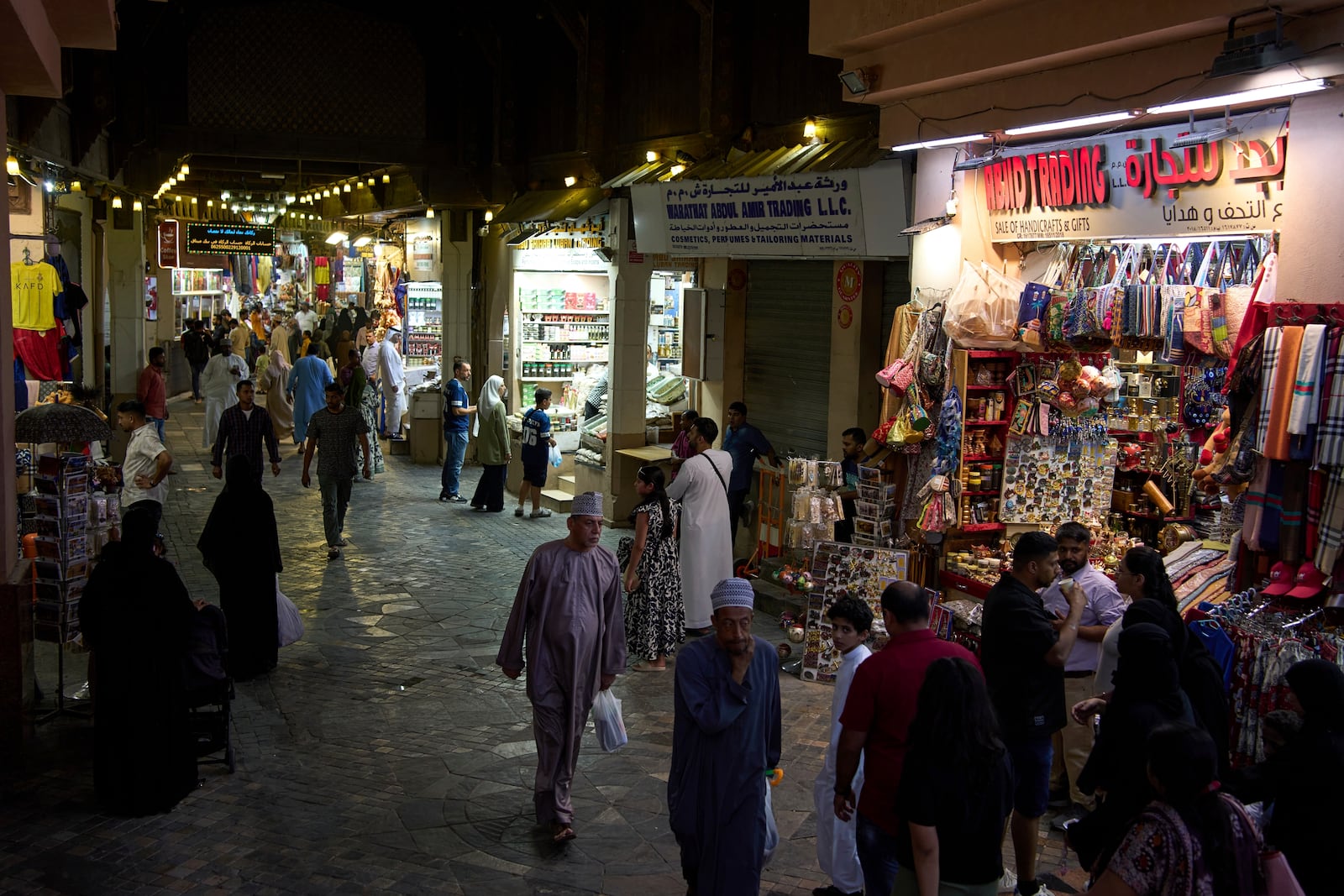 People walk through Mutrah Souq in Muscat, Oman, Friday, April 11, 2025. (AP Photo/ Fatima Shbair)