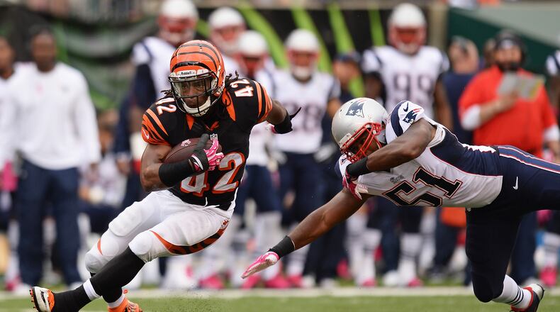 CINCINNATI, OH - OCTOBER 6: BenJarvus Green-Ellis #42 of the Cincinnati Bengals breaks a tackle attempt from Jerod Mayo #51 of the New England Patriots in the first quarter while gaining yardage at Paul Brown Stadium on October 6, 2013 in Cincinnati, Ohio. (Photo by Jamie Sabau/Getty Images)