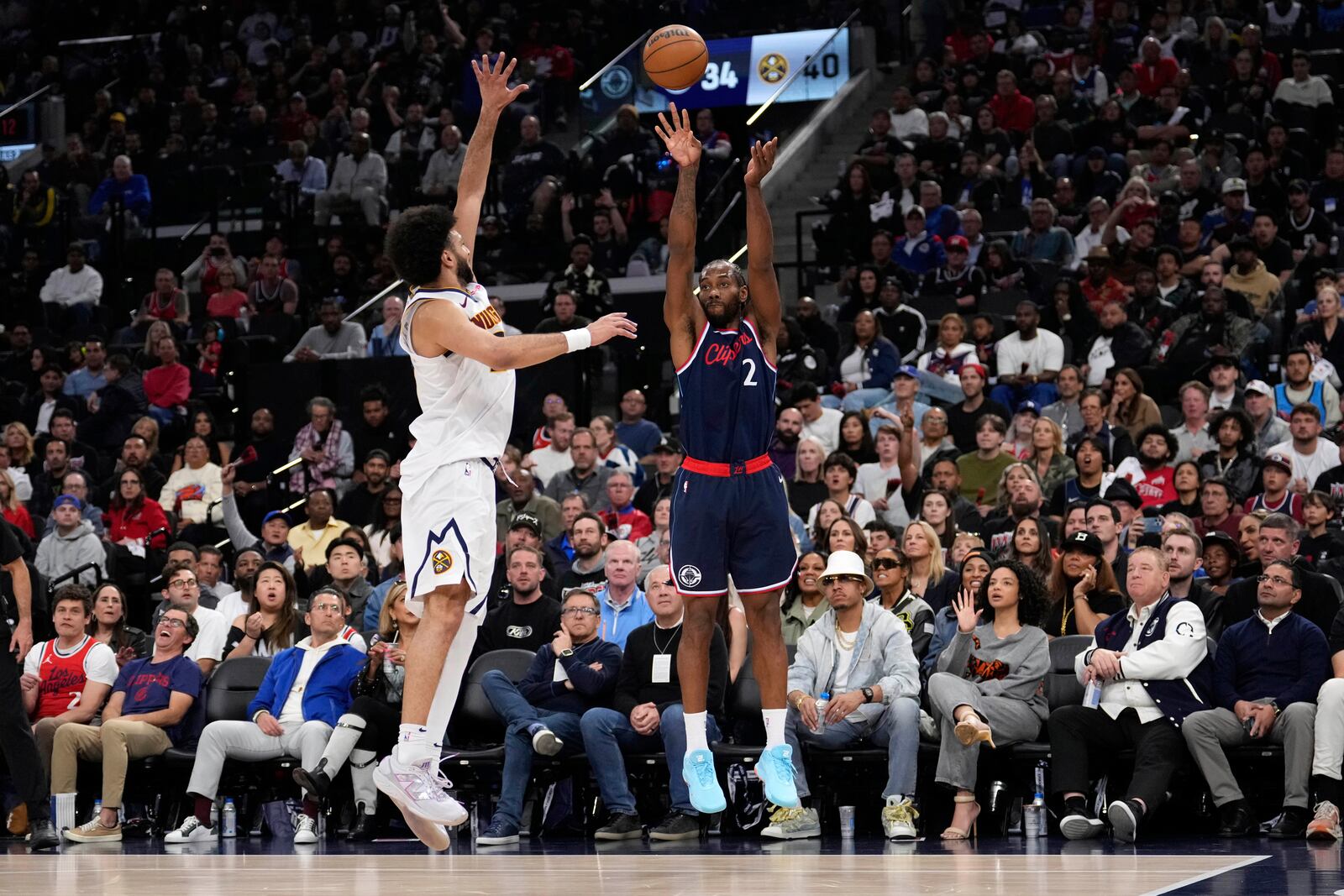 Los Angeles Clippers forward Kawhi Leonard, right, shoots as Denver Nuggets guard Jamal Murray, left, defends during the first half in Game 4 of an NBA basketball first-round playoff series Saturday, April 26, 2025, in Inglewood, Calif. (AP Photo/Mark J. Terrill)