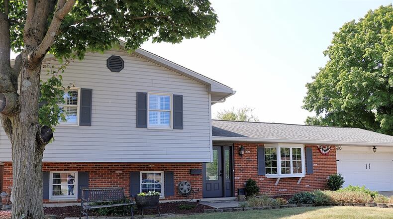 A home for sale at 305 Mound St. in Brookville has an in-ground swimming pool, covered patio, fire pit and waterfalls with a pond. CONTRIBUTED