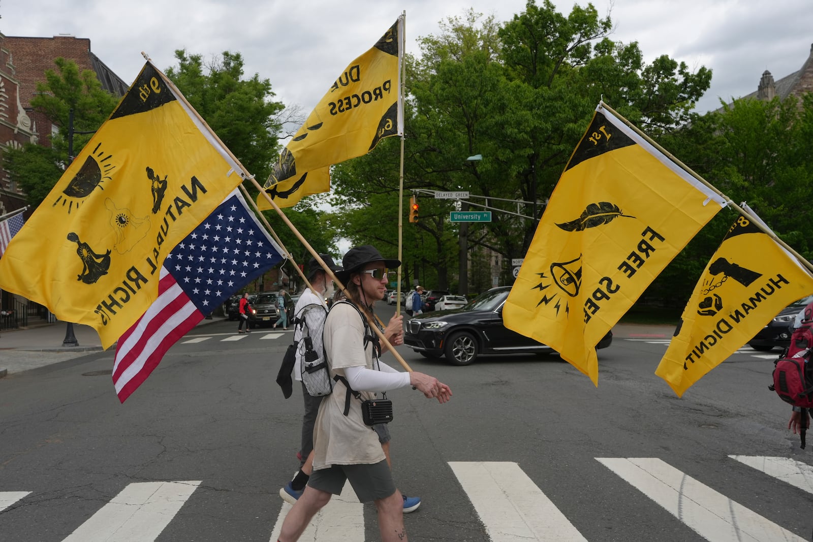 Ross Brubeck and other members of the Quaker March to Washington cross a street on their way to a meeting house in Princeton, N.J., on Wednesday May 7, 2025. (AP Photo/Luis Andres Henao)