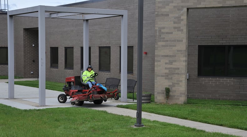 88th Civil Engineer Squadron gardener, Madlyn Hensley, mows the lawn near the flight line. Maintaining the grounds has a direct effect on the base appearance, which in turn has positive effects on morale. (U.S. Air Force photo/Loren Deer)