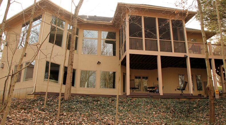 The main level has a screen-enclosed porch with carpeting, paddle fan and is accessible from the breakfasts room and the main bedroom. The porch opens out to a balcony deck with steps that lead down to the lower deck and wooded back yard.