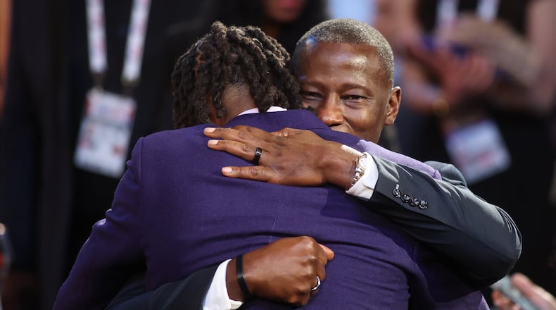 DaRon Holmes hugs Dayton's Anthony Grant after being selected with the No. 22 pick in the NBA Draft on Wednesday, June 26, 2024, at the Barclays Center in Brooklyn, N.Y. David Jablonski/Staff