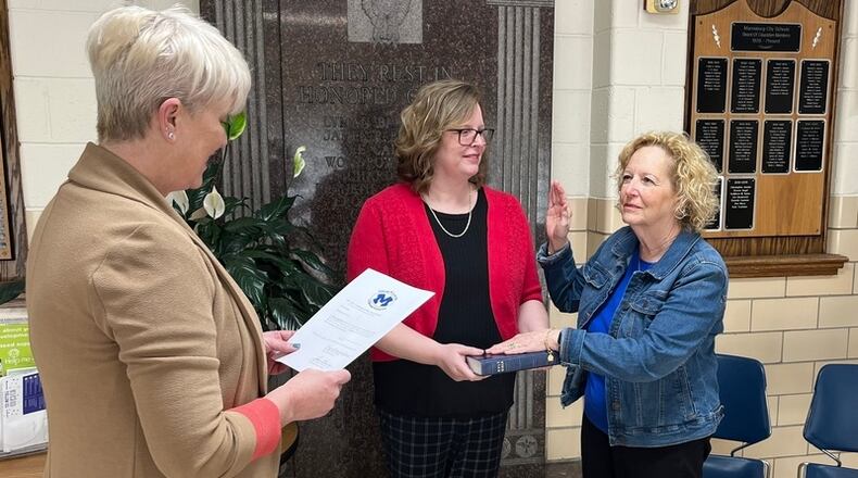 Nila Taylor Getter (right) was sworn in as a member of the Miamisburg City School District Board of Education, Tuesday, April 25, 2023, by Miamisburg Mayor Michelle Collins (left) with her daughter, Elisabeth Middleton, at her side. CONTRIBUTED