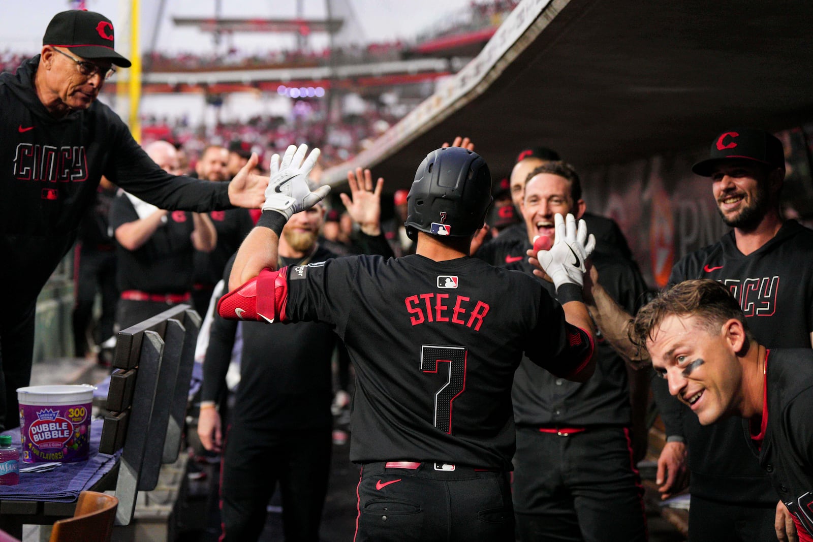 Cincinnati Reds' Spencer Steer (7) celebrates with teammates after hitting a two-run home run during the fifth inning of a baseball game against the San Diego Padres, Friday, June 27, 2025, in Cincinnati. (AP Photo/Jeff Dean)