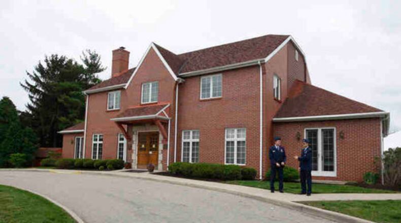 Air Force personnel stand outside the original Fisher House at Wright-Patterson Air Force Base. There is also a Fisher House II at the base.