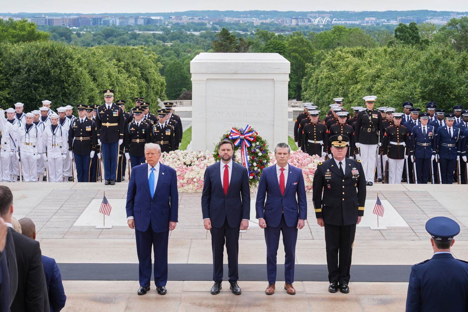 President Donald Trump, Vice President JD Vance, Secretary of Defense Pete Hegseth and Major General Trevor Bredenkamp, commanding general of the Joint Task Force-National Capital Region and the U.S. Army Military District of Washington, right, attend a Memorial Day wreath laying ceremony at Arlington National Cemetery, in Arlington, Va., Monday, May 26, 2025. (AP Photo/Jacquelyn Martin)