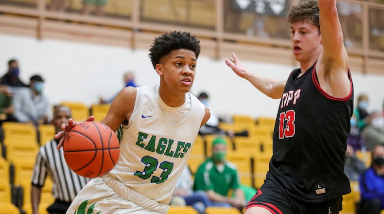 Chaminade Julienne High School freshman Jonathan Powell drives past Tippecanoe senior Ben Knostman during their game on Thursday night at the Vandalia Butler Student Activity Center. The Eagles won 58-55. Michael Cooper/CONTRIBUTED