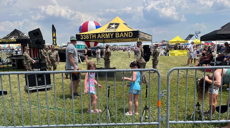 Children dousing themselves Saturday at a CenterPoint Energy Dayton Air Show misting station. Saturday's high temperature at the Dayton International Airport reached the low 90s. THOMAS GNAU/STAFF