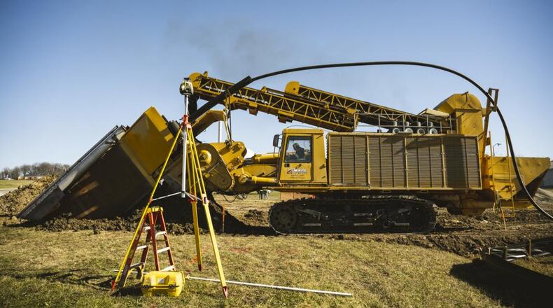 A DeWind construction worker uses the trencher Nov. 21 to dig a 30-foot-deep trench at Wright-Patterson Air Force Base. The trencher digs, lays the pipe and fills the trench in one efficient and environmentally friendly pass. (U.S. Air Force photo by Hannah Carranza)