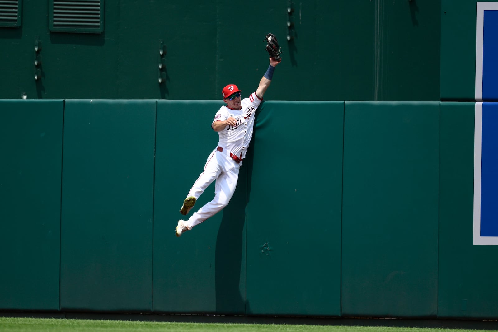 Washington Nationals center fielder Jacob Young makes a catch on a fly ball by Cincinnati Reds' Will Benson for an out during the eighth inning of a baseball game, Wednesday, July 23, 2025, in Washington. (AP Photo/Nick Wass)