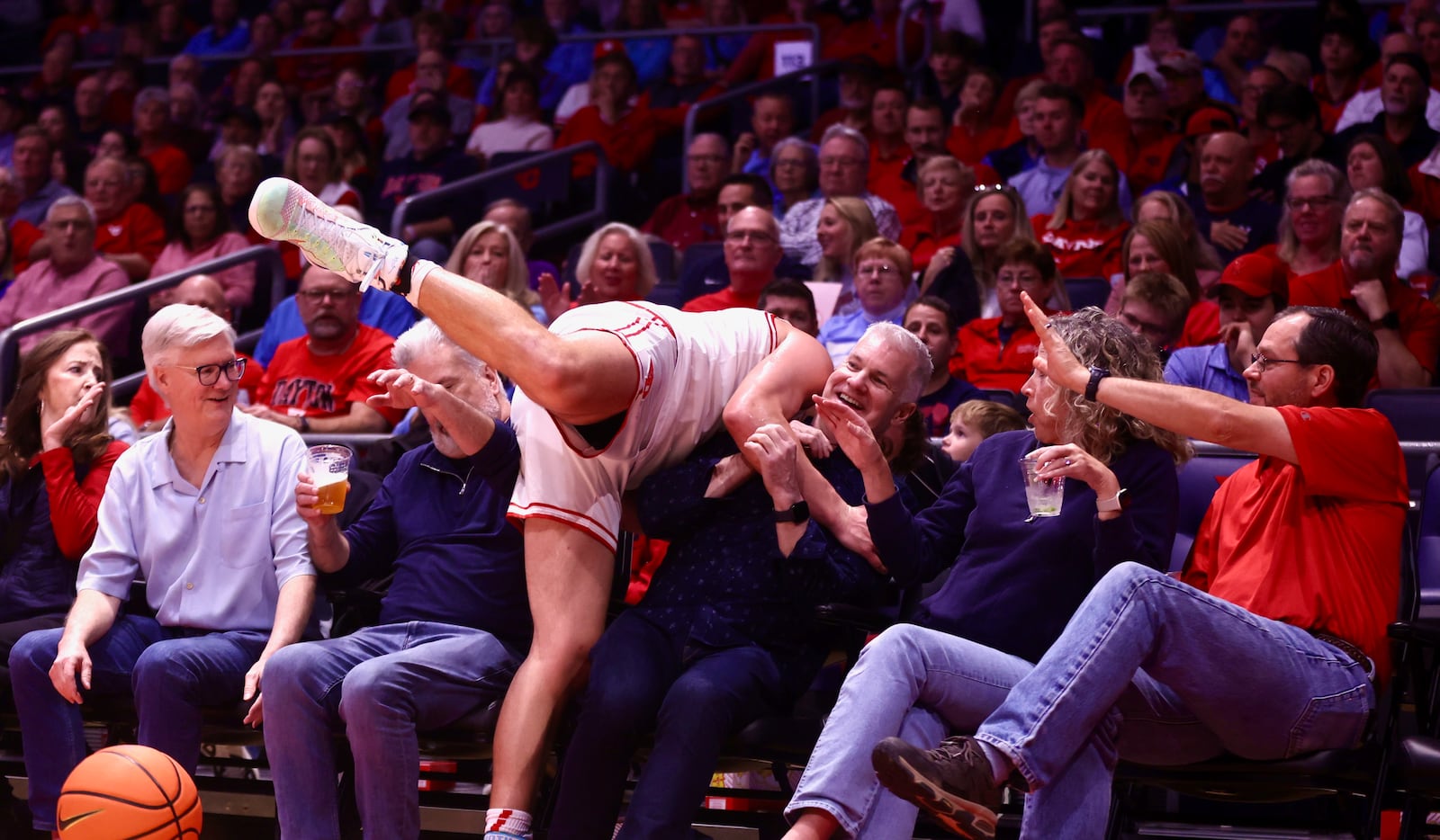 Dayton's Jordan Derkack falls into the crowd during a game against Bethune-Cookman on Saturday, Nov. 15, 2025, at UD Arena. David Jablonski/Staff